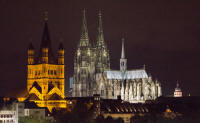Groß St Martin basilica and Cologne cathedral from the east bank of the Rhine, at night