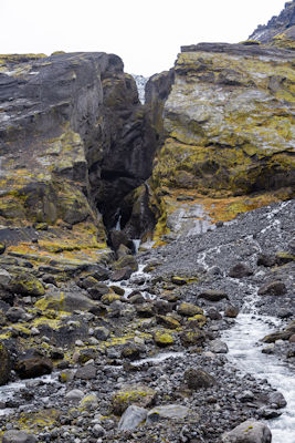 Huge split rock with waterfall running through it