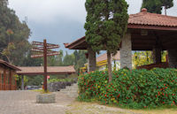 Signpost to mountains, in grounds of Jiwa Jawa Resort hotel