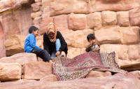 Bedouin family selling rugs