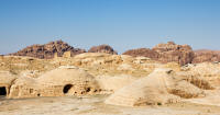Dwellings and ruined castle (background) on the way to Little Petra