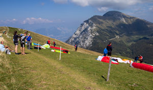 Preparation for paragliding on eastern slope of Monte Baldo