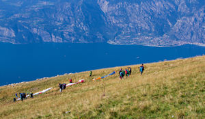 Preparing paragliders on western side of Monte Baldo, Limone in background