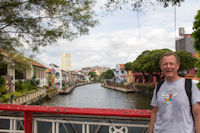 Blinking tourist on bridge over Malacca River near the Clock Tower, looking NE