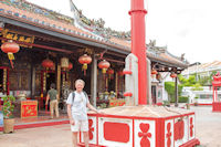 Tourist by flag pole of Cheng Hoon Teng temple