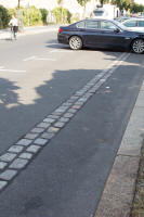 Double line of cobblestones tracing the former Wall